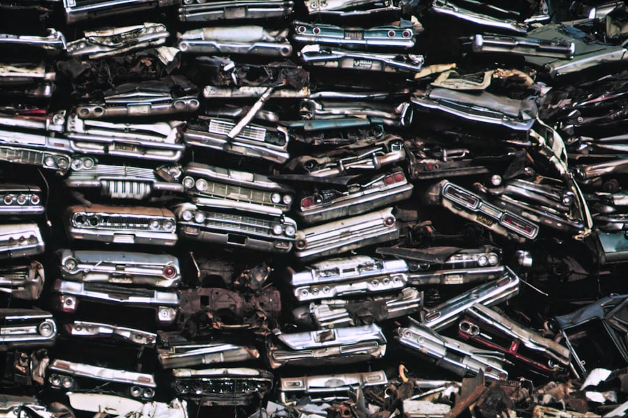 Stacked wrecked rail carriages at a salvage yard