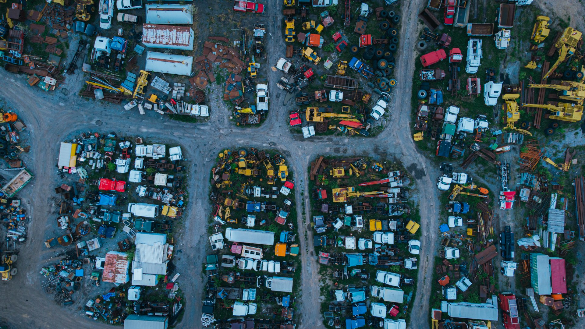 Aerial view of an African insurance salvage yard with damaged vehicles and industrial assets